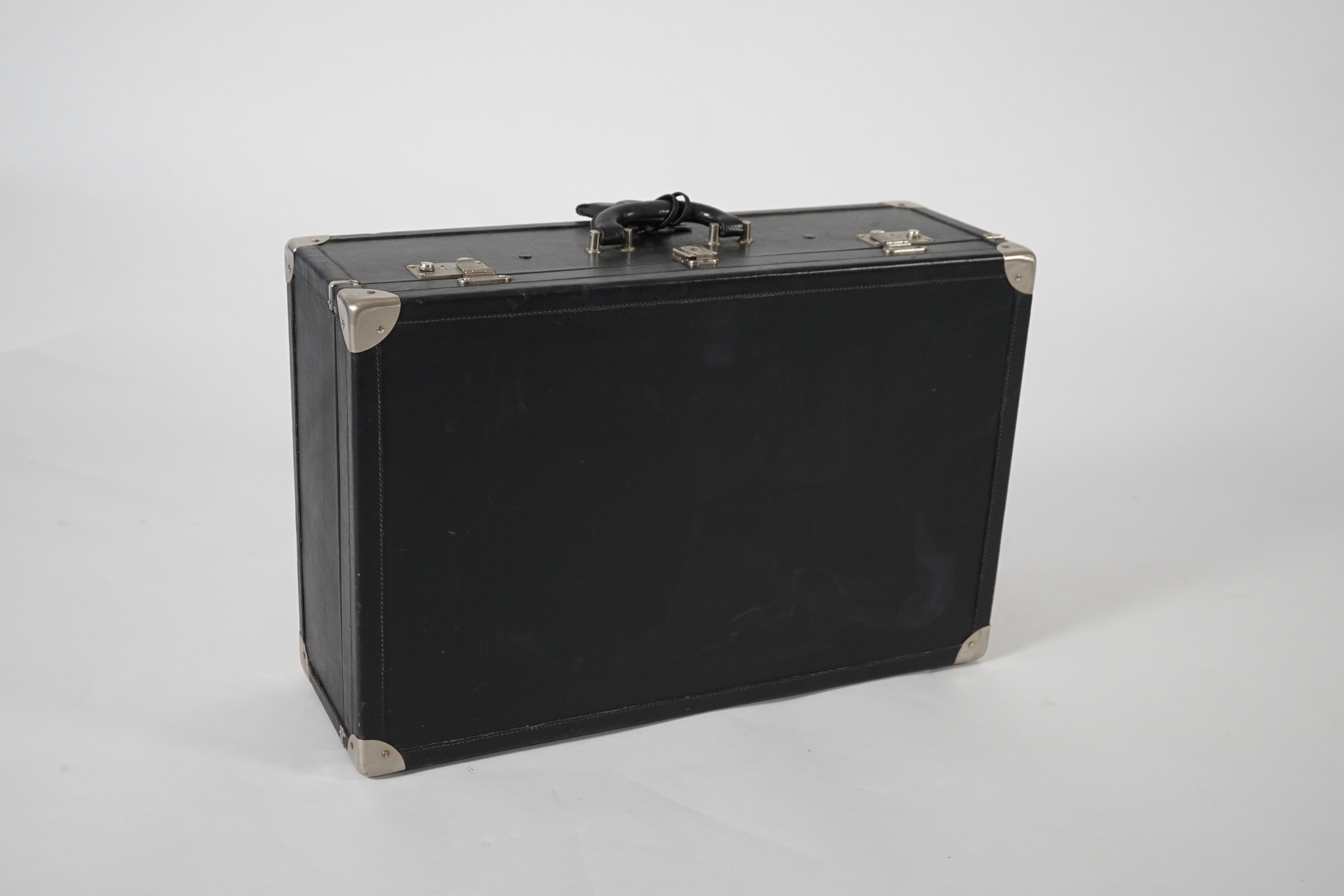 A Nina Cerruti black leather suitcase Length 64.5cm, depth 22cm, width 42cm